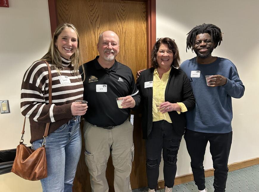 Alumni, staff and current athletic training students at a reception celebrating 20 years of accreditation for the NWU athletic program. 